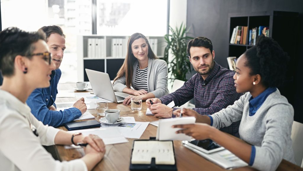 A team engaged in a mortgage JV consulting meeting, discussing joint venture opportunities and mortgage consulting strategies to ensure industry compliance and business growth.